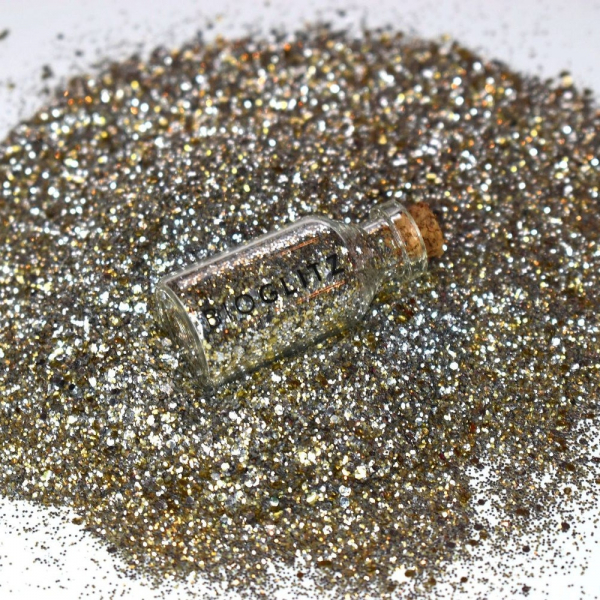BioGlitz Treasure Chest pile of gold glitter with corked transparent vial of gold glitter in the middle